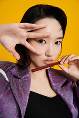 Fashion portrait with bold makeup and colorful background.