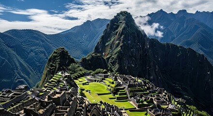 Mountain city ruins amidst verdant peaks under a cloudy sky