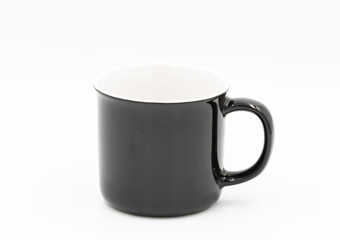 Black and white empty coffee mug standing on white background
