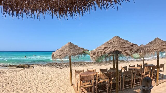Chairs and umbrellas on Playa Arenals in Formentera, Spain.