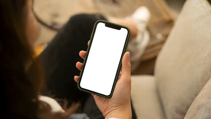 a hand holds a modern smartphone with a blank white screen, ideal for digital app and website mockups.