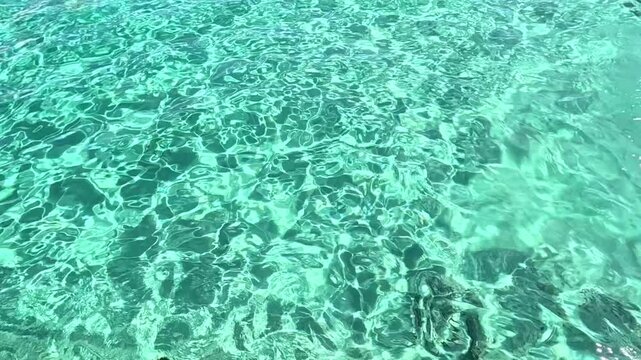 Formentera. Sunlight creating sparkling reflections and patterns on the calm, rippling surface in slow motion. Water background. 
