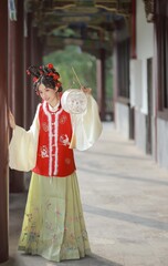 Young woman in traditional dress holding a lantern Chinese word means lantern.
