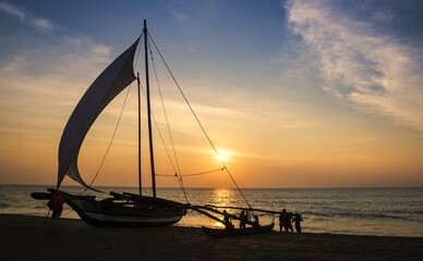 Oruwa traditional fishing sailboat at Negombo Beach at sunset, Negombo, Gampaha District,...