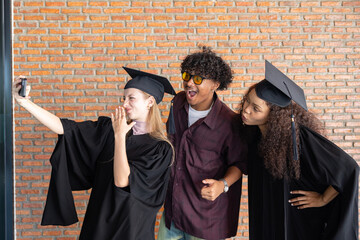 Graduates taking celebratory selfie on graduation day