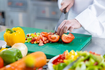 Close-up of chef dicing fresh vegetables