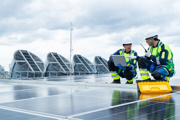 Engineers analyzing solar panel data on rooftop