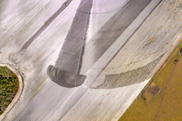 Sprinkler irrigation system watering farm field during dry season. Spraying water on farmland ground for crop growth during period of drought