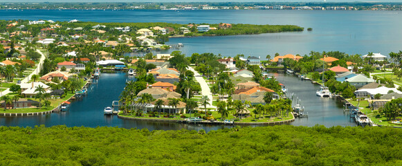 Aerial view of residential suburbs with private homes located on gulf coast near wildlife wetlands...