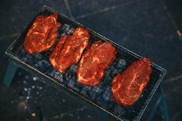 A vibrant outdoor barbecue scene with people grilling shashlik and marinated vegetables over an...