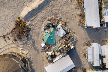 Storm surge severe damage to residential houses on ocean shore after hurricane landfall. Natural...