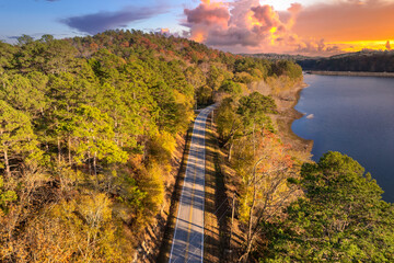 Road trip in fall season through Appalachian forest in Tennessee. Car driving on a winding road under colorful autumn canopy