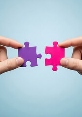 Human hands holding colorful puzzle pieces illustrating connection and partnership