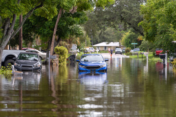 Flooded street with stuck cars after hurricane rainfall in Florida. Aftermath of natural disaster caused by global warming