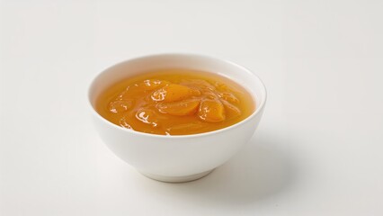 Delicious Apricot Preserve in a Bowl Against a White Backdrop