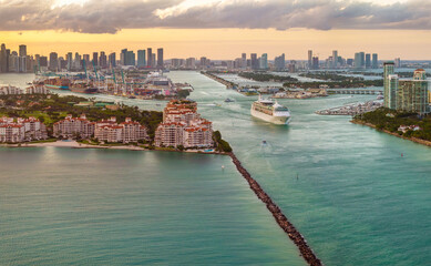 Big passenger cruise liner ship departing at main channel in Miami harbor near South Beach high...