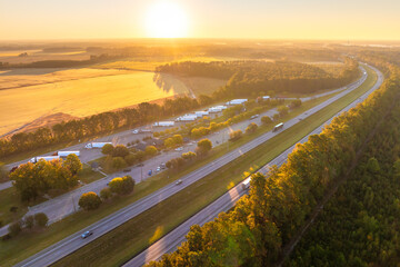 Big parking truck stop for tractor trailers rest area near busy American highway. Hauling cargo...
