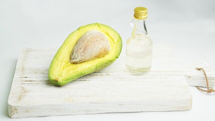 avocado and virgin coconut oil on white background, selective focus