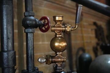 Papplewick Pumping Station, Nottingham, England – August 10 2025: Close up view of a Victorian brass steam valve in Nottingham's historic pumping station.