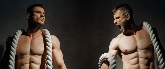 Muscular model sports young man on dark background. Guy with the rope is doing a workout. athlete...