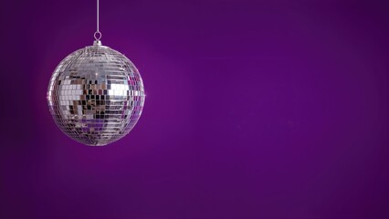 Glittering orb set on a purple canvas. Celebration spirit, joyful event, seasonal party. Holiday cheer, masquerade, carnival atmosphere.