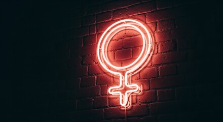 Neon sign of venus symbol glowing against dark brick wall creates focal point. Venus symbol highlights strength and beauty, representing femininity and female empowerment.