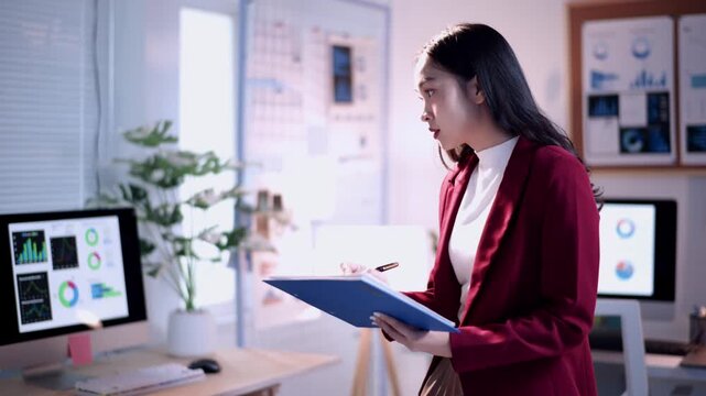 Businesswoman presenting business plan using pen and folder