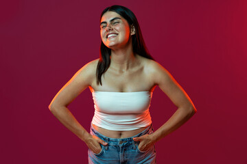 Smiling young woman embracing natural beauty in studio