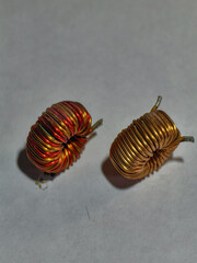 Close-up shot of two copper wire coils, electronic components ready for use.