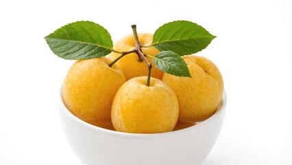 Bright yellow plums ripe and sweet in a bowl