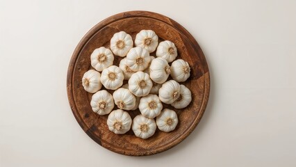 Overhead shot of garlic placed on a rustic wooden tray
