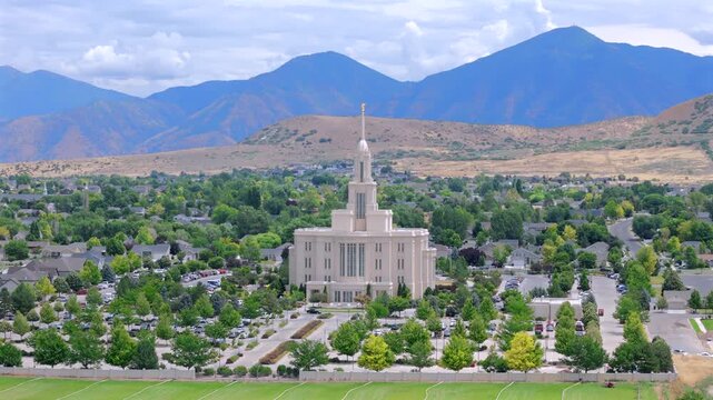 Captivating aerial footage presents the Payson Utah Mormon Temple, revealing its stunning and majestic architectural features set against the beautiful and scenic backdrop of surrounding mountains