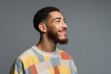 cheerful man wearing ultrabright tshirt is smiling and gazing into distance radiating hope