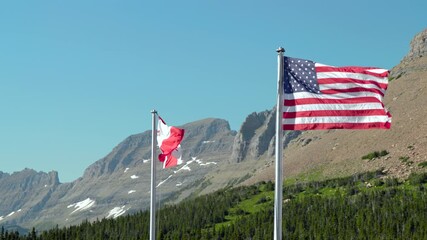 The sight of the Canadian and American flags fluttering against a mountain backdrop symbolizes the unity and friendship between these nations, highlighting their cultural ties and shared history - Powered by Adobe