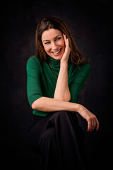 Brunette haired woman against isolated dark background