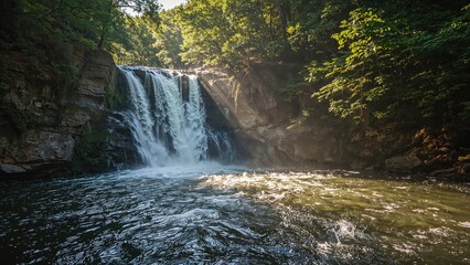 Obraz premium Gazing Down a Cascading Waterfall Along a Scenic Mountain Road