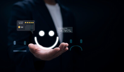 Businessman hand holding glowing smile face icon with 5 star customer review rating, positive feedback, satisfaction survey, client experience and online reputation management concept