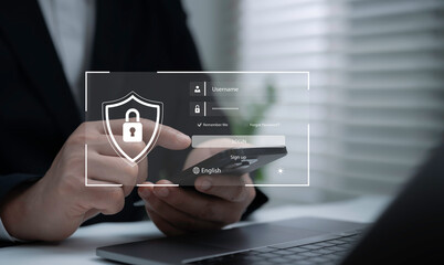 Businessman using smartphone with virtual login interface and security shield icon, cybersecurity,...