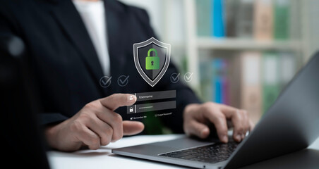 Businessman using laptop with virtual secure login interface and green padlock shield icon,...