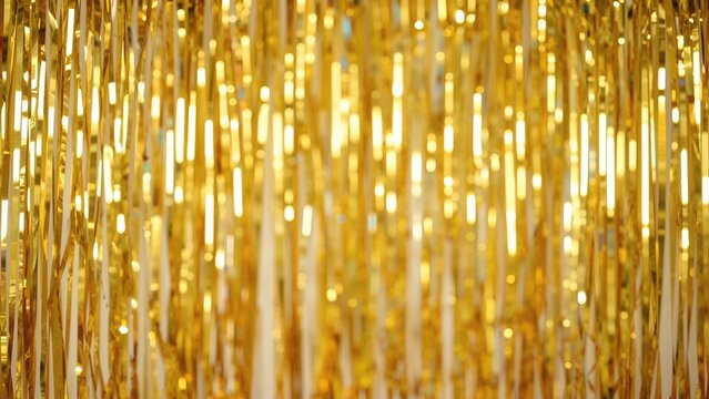 Abstract yellow metallic foil backdrop with draped fabric, perfect for festive occasions and party decorations.