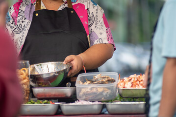 Street Vendor Prepares Fresh Seafood Dishes