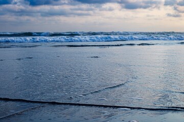 Waves Rolling on Sandy Beach at Dusk, ocean background, wave close up, beauty beach.