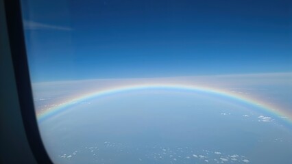 Aerial View of a Circular Rainbow Through an Aircraft Window