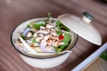 Sweet and spicy mango salad in a bowl, often eat with deep fried fish with fish sauce. Thai food