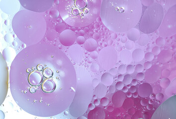 The whimsical mixture of pink and soft lilac oil drops creates an abstract psychedelic effect,...