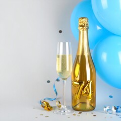 Fototapeta premium Champagne bottle and glass with number 74. Festive photo for birthday or anniversary party