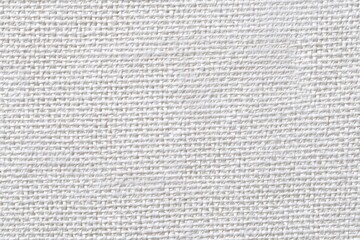 Close-up of a plain white woven fabric.  Fine, even weave, creating a grid pattern