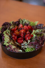 Salad served in a bowl, on the table