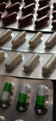 Assorted Capsules and Blister Packs on Dark Surface