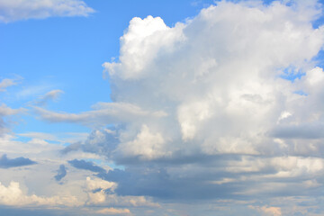 Fluffy Cumulus Clouds Against a Bright Blue Sky sky background